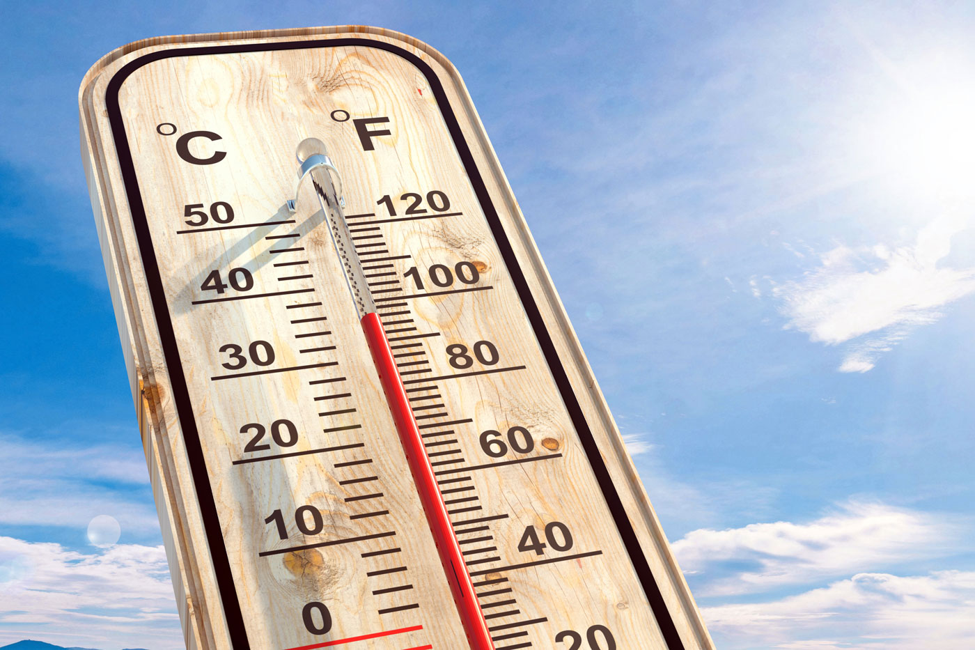 thermometer with sun and clear sky